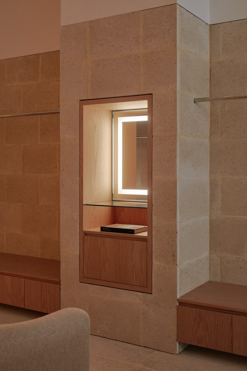 Timber-lined niche with an illuminated mirror