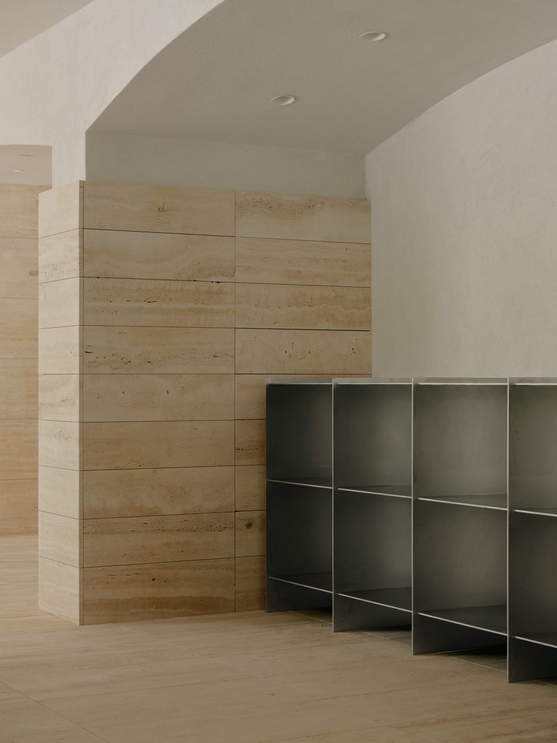 Steel shelving unit against a travertine wall