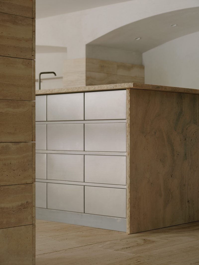 Travertine kitchen with brushed steel drawers